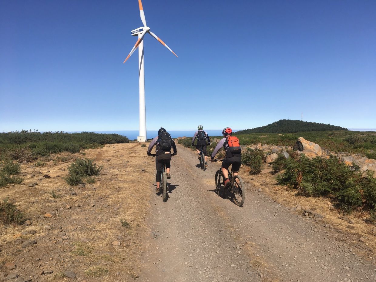 Bikers heading towards a wind mill